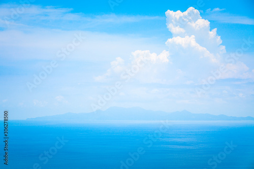 Background Texture of Ocean Skyline with Tropical Beach against Blue Sky and White Clouds in Summer Sunny Day © Ketsarin