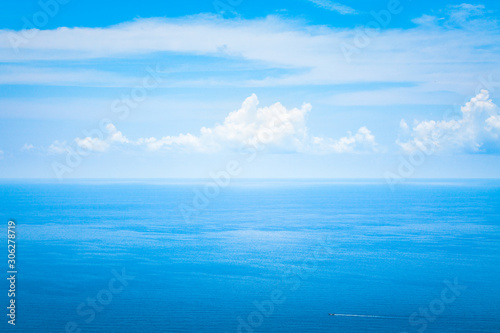 Background Texture of Ocean Skyline with Tropical Beach against Blue Sky and White Clouds in Summer Sunny Day © Ketsarin