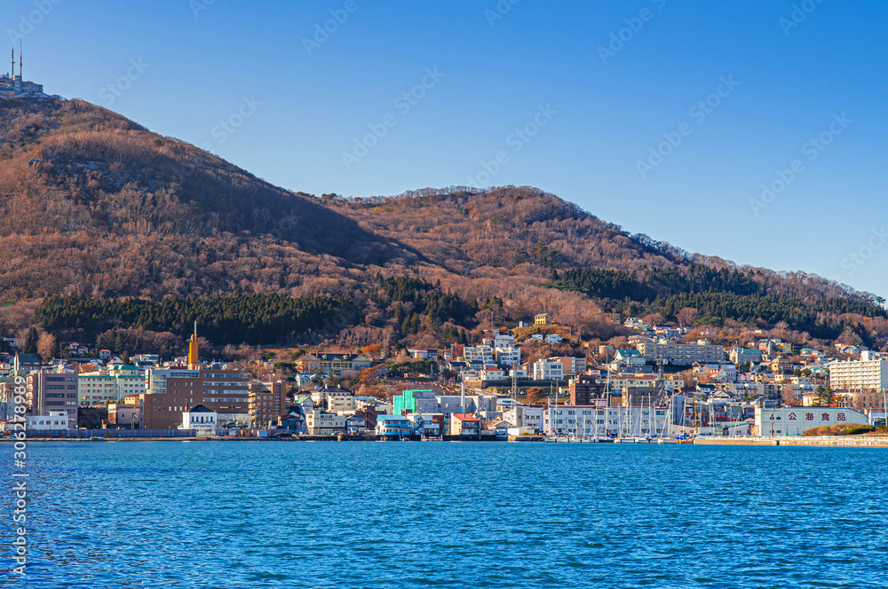 Hakodate blue harbour bay and Motomachi cityscape buildings with mount Hakodate