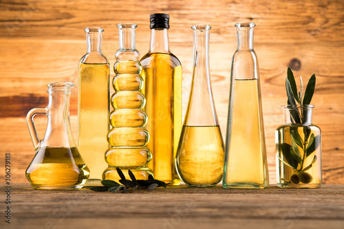 Fototapeta Naklejka Na Ścianę i Meble -  Olive oil bottles, olive branch and Cooking oils