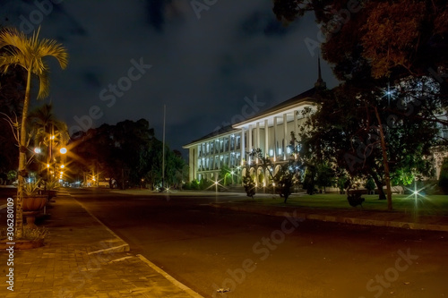 Outdoor Exterior UGM Central Building At Night. The First Modern Building Symbol Made in Indonesia - Gadjah Mada University. © Supriyanto