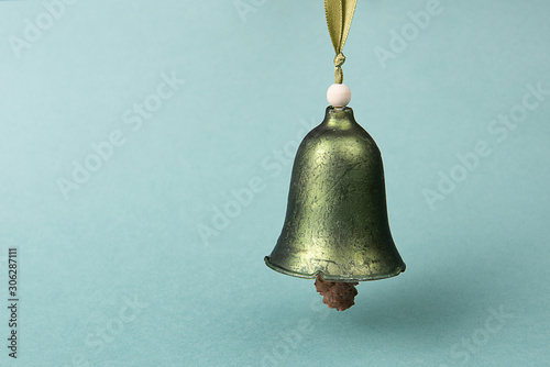 Christmas bell against defocused colored background. Christmas banner.