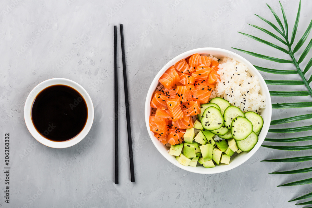 Hawaiian salmon bowl with cucumbers, avocado, sesame seeds and rice