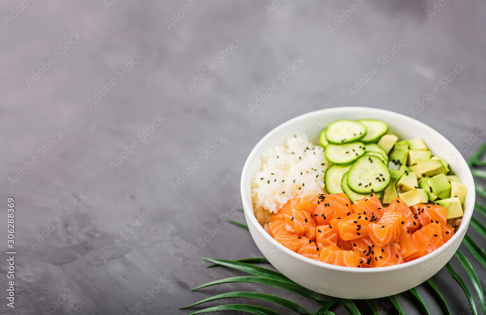 Hawaiian salmon bowl with cucumbers, avocado, sesame seeds and rice