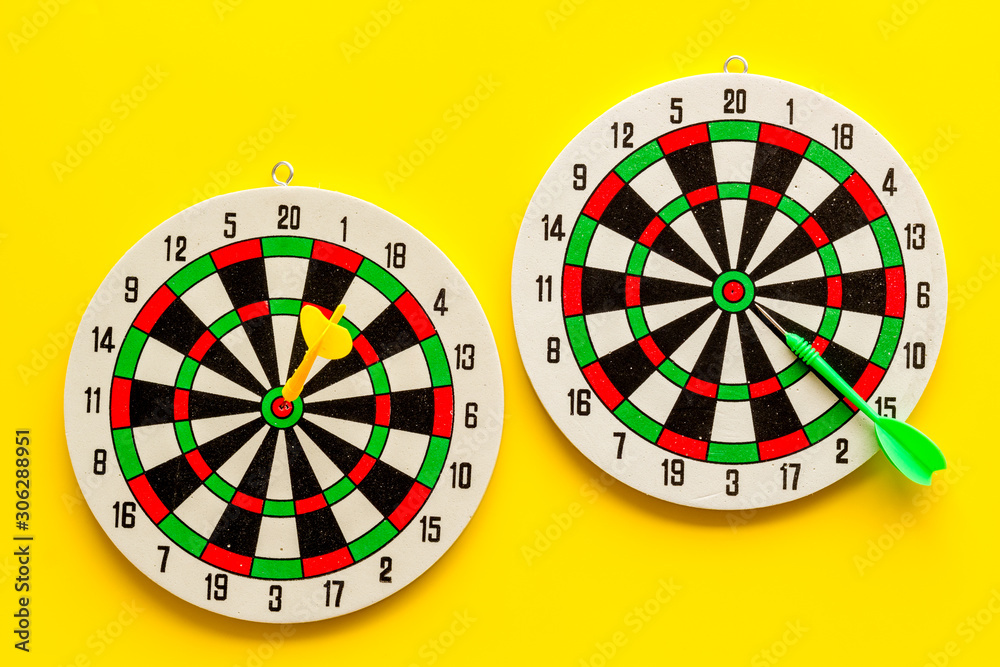 Choose business strategy concept. Dartboard with paper for text on yellow background top view Choose business strategy concept. Dartboard with paper for text on yellow background top view