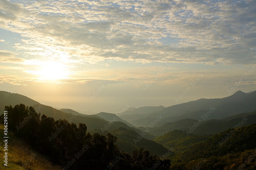 Sunrise on a cloudy morning on a green mountain landscape into the wilds in Catalonia