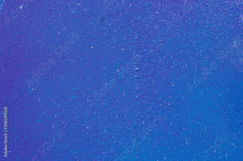 Textured color wall is blue, paint splashes are white. The background photo.