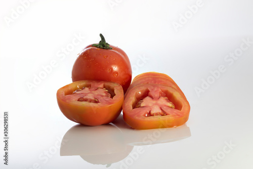 Half of fresh cherry tomato isolated on white