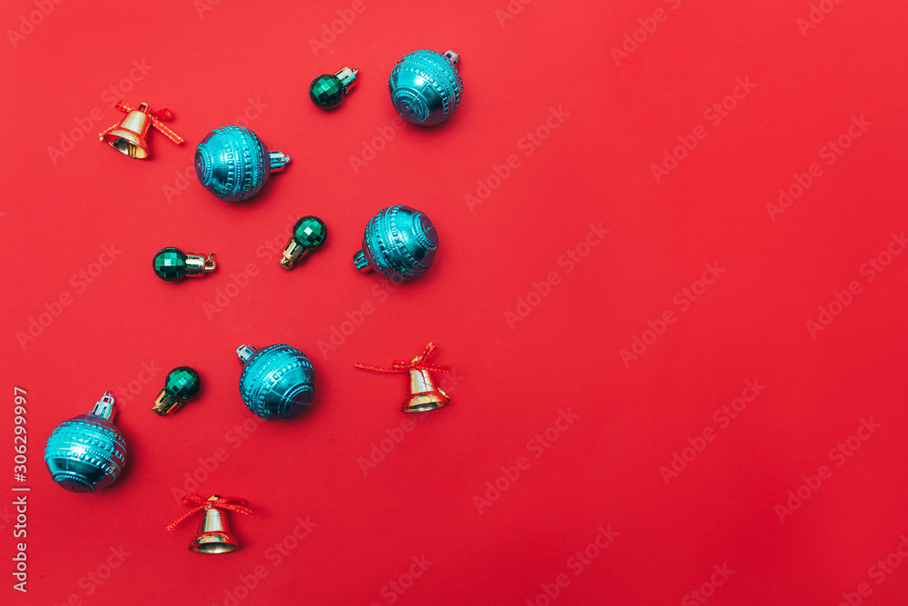 Red background with christmas balls in the corner, space for text, flat lay. Red background with christmas balls in the corner, space for text, flat lay.
