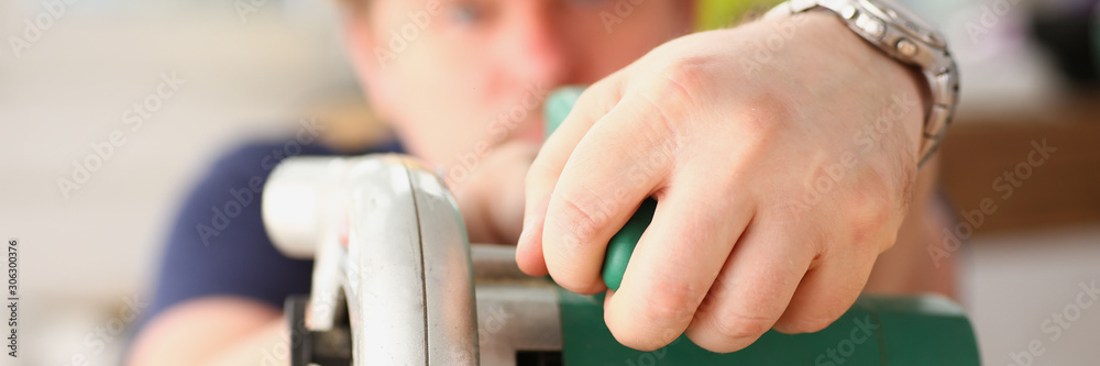 Worker using electric saw portrait Worker using electric saw portrait