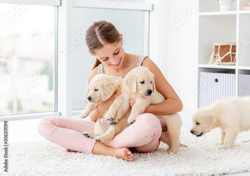 Girl holding retriever puppy