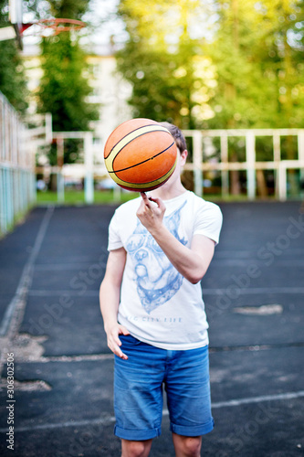 Man holding basketball ball on the urban city court.