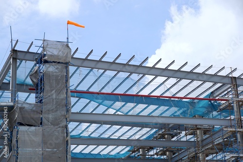 The structure of building with blue sky and cloud as a background, Steel construction in large construction site, Space for text in template