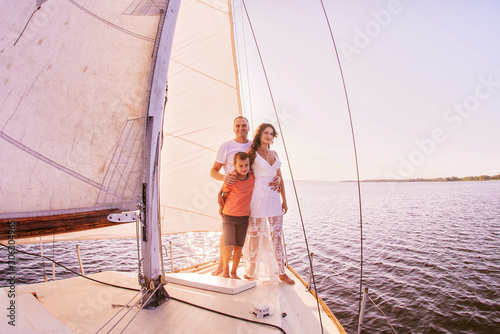 Happy family sailing on a luxury yacht or catamaran boat © VlaDee