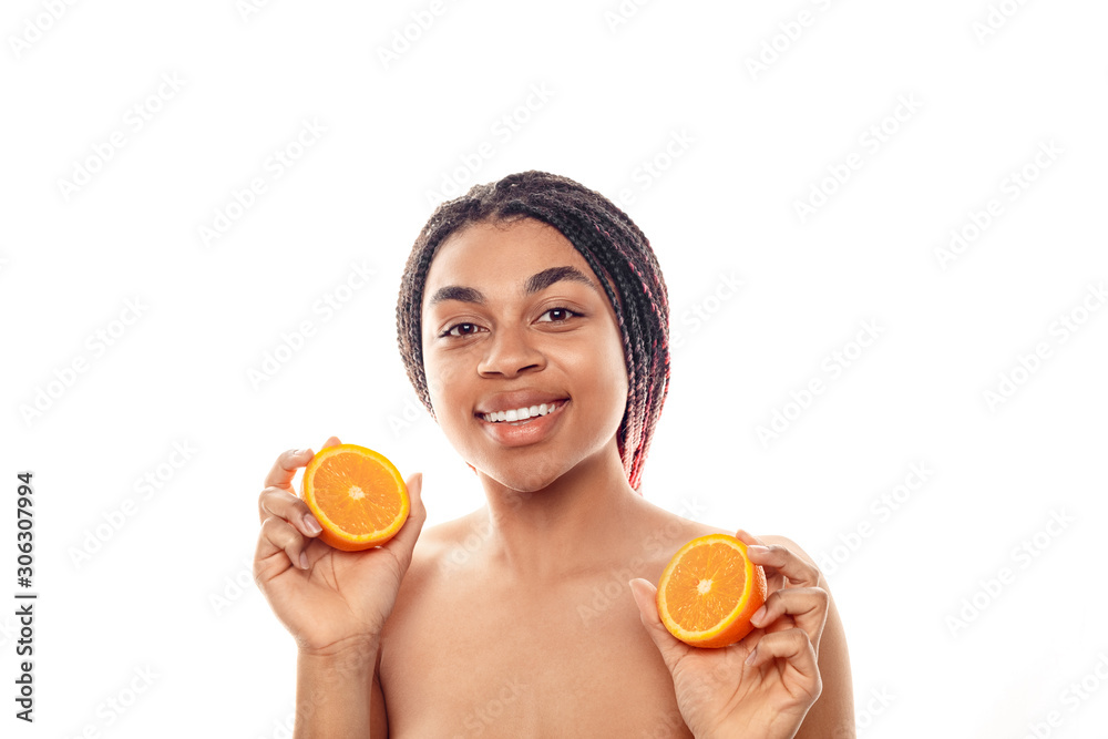 Beauty Concept. Young african woman isolated on white with orange halves posing smiling happy close-up Beauty Concept. Young african woman isolated on white with orange halves posing smiling happy close-up