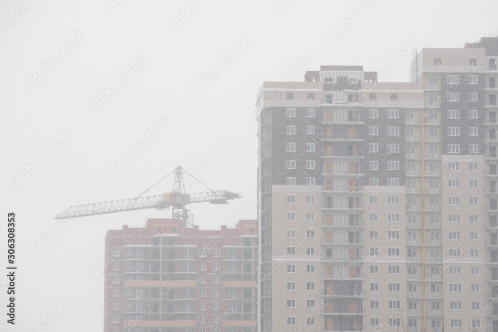 Winter. Snowfall in the city. Houses are covered with snow. Winter. Snowfall in the city. Houses are covered with snow.
