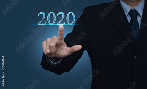 Businessman pressing 2020 text over light gradient blue background, Happy new year 2020 calendar cover concept