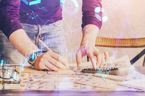 Multi exposure of man standing and planing investment with stock market forex chart.