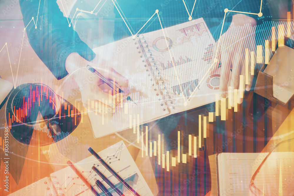 Double exposure of hands making notes with forex chart huds. Stock market concept. Double exposure of hands making notes with forex chart huds. Stock market concept.
