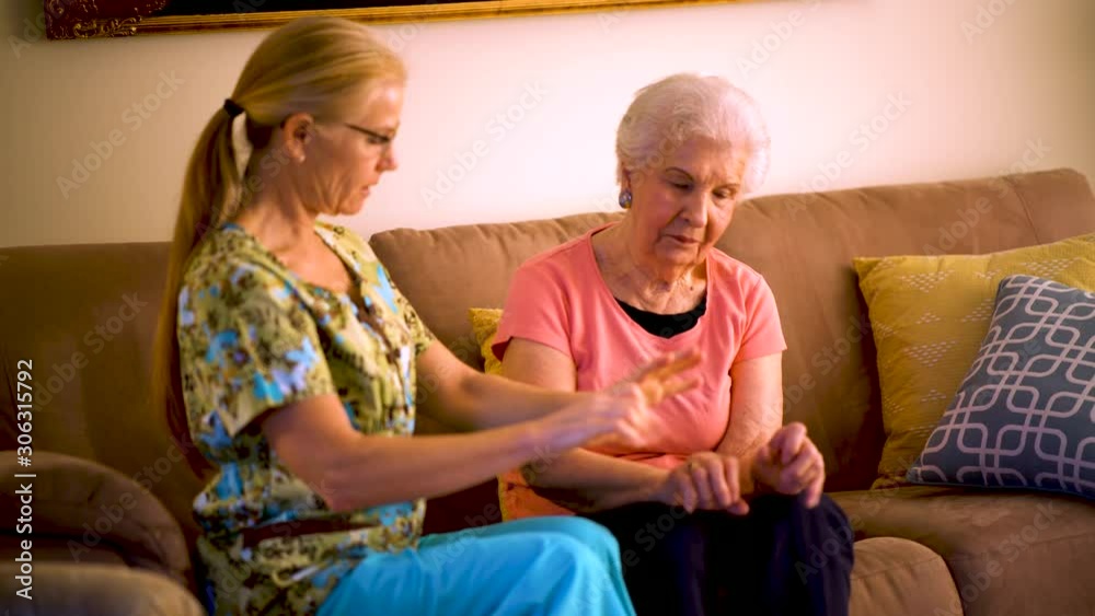 Home healthcare therapist helping elderly woman with arm stretches. Home healthcare therapist helping elderly woman with arm stretches.