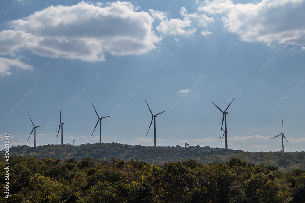 Wind turbines or wind wheels and blue sky background. Wind turbines or wind wheels and blue sky background.