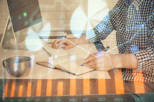 Double exposure of stock market chart with man working on computer on background. Concept of financial analysis.