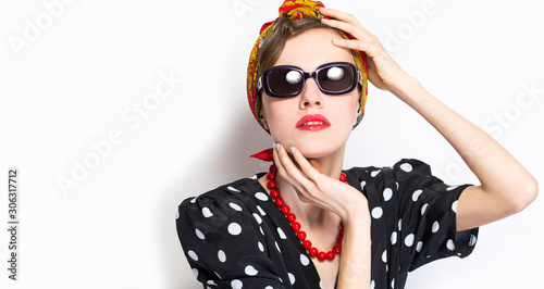 Fashion woman in scarf and sunglasses over white