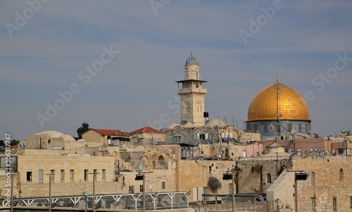 View at Temple Mount in Jerusalem, golden cupola of Dome of the Rock, minaret next to, characteristic stony architecture
