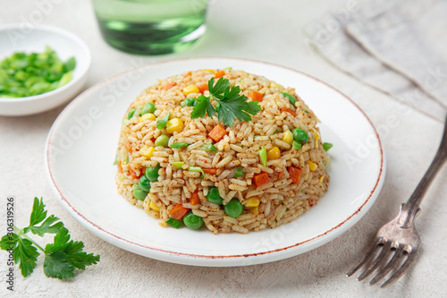 fried rice with vegetables on white plate