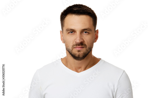 Portrait of young frowned handsome bearded man on white background. facial expression © producer