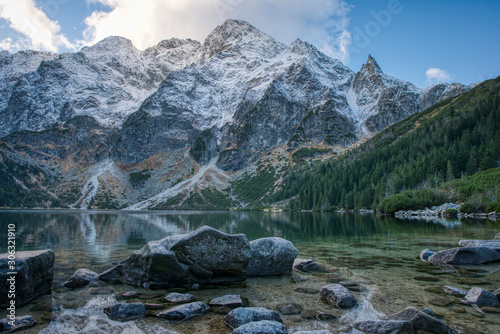Fototapeta Naklejka Na Ścianę i Meble -  Sea eye in High Tatras with little snow on mountains around , Poland Morskie Oko , tatry