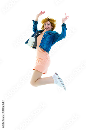 Full length portrait of a cheerful cute woman jumping isolated o