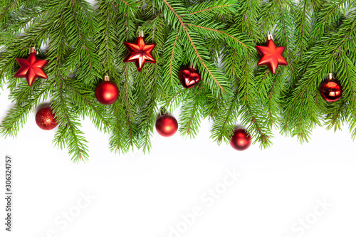 Branches of spruce on a white isolated background. Red Christmas toys  balls. Creative frame for new year cards. Christmas decoration.