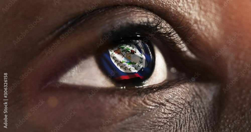 Woman black eye in close up with the flag of Belize in iris with wind motion. video concept