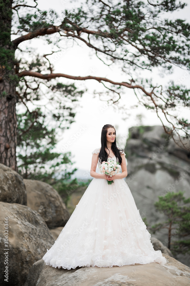 Luxury wedding bride, girl posing and smiling with bouquet