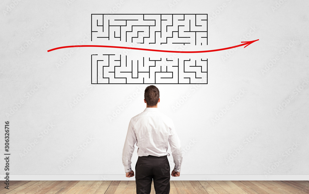 Businessman in doubt looking to a maze and searching the way out Businessman in doubt looking to a maze and searching the way out