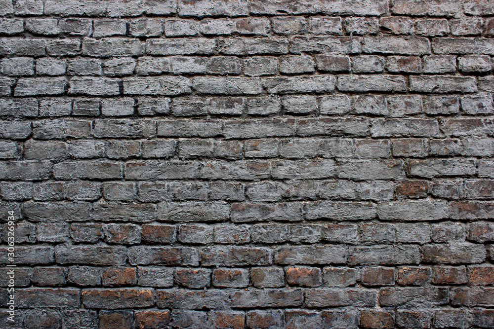 Obraz premium Dirty old weathered grey painted reddish brickwork wall background texture