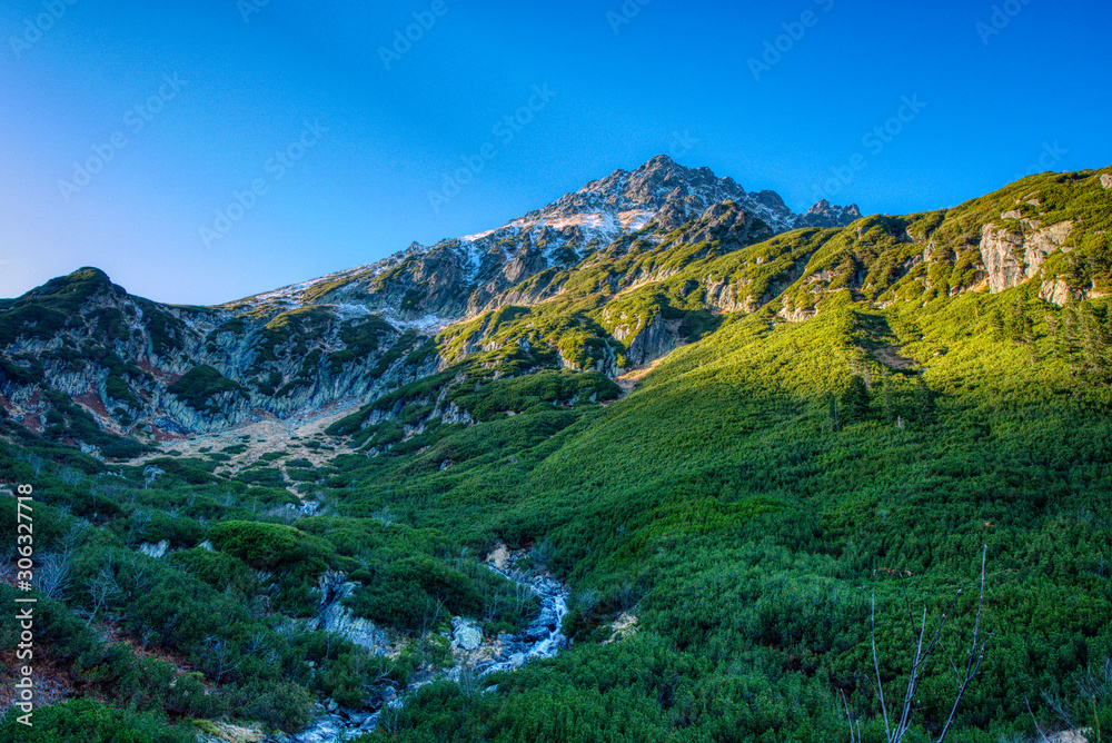 Gorgeous mountain in Tatras with river below it in autumn , Poland Bucinova straznica Gorgeous mountain in Tatras with river below it in autumn , Poland Bucinova straznica