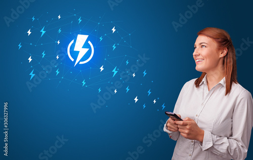 Young person using phone with power concept photo