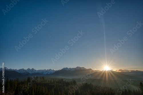 view of High Tatras mountains when they are snowy at sunset on Polish side © Martin