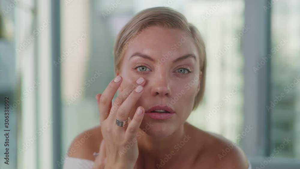 Beauty blogger applying make up, looking in mirror, moisturizing lipstick, close up of face features, shot on Red Weapon Helium