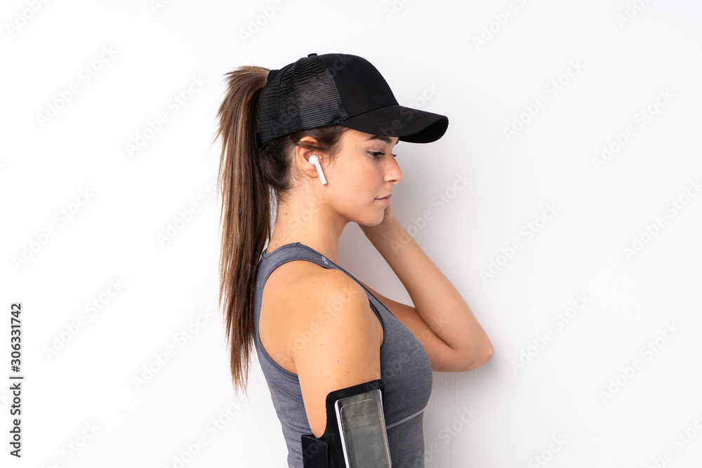 Teenager Brazilian sport girl over isolated white background listening music Teenager Brazilian sport girl over isolated white background listening music