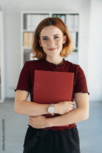 Smart young job applicant clutching her CV