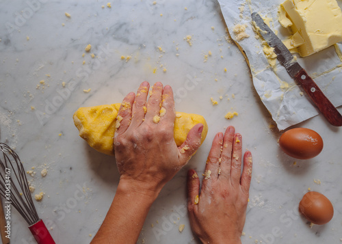 making dough, caucasian woman hands making a dough with flour eggs and butter. homemade pastry. white background 2