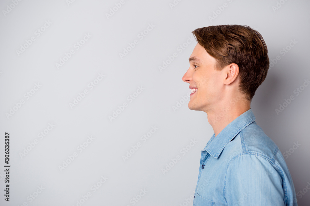 Profile side photo of cheerful content guy stare copyspace listen to his friend conversation wear modern outfit isolated over grey color background Profile side photo of cheerful content guy stare copyspace listen to his friend conversation wear modern outfit isolated over grey color background
