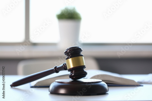 The judge hammer lies on table in