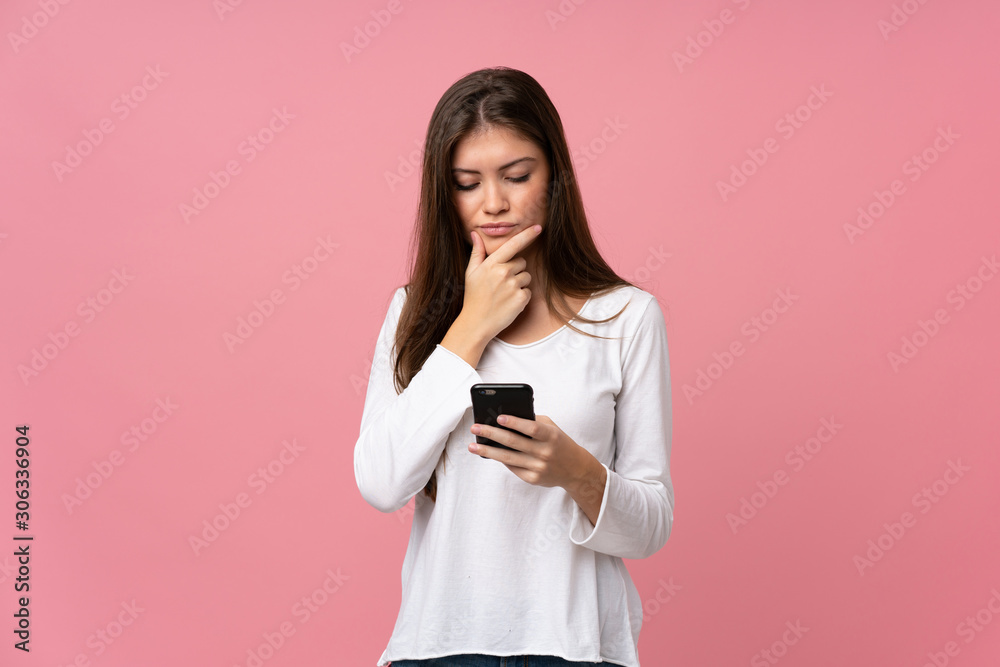 Young woman over isolated pink background thinking and sending a message Young woman over isolated pink background thinking and sending a message