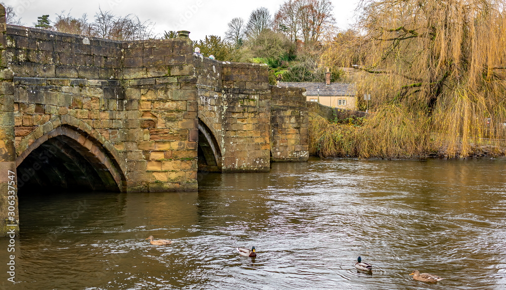 Fototapeta premium Ancient stone bridge over the River Wye in the Derbyshire town of Bakewell
