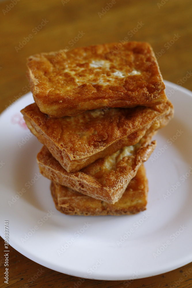 Stack of freshly fried tokwa or tofu Stack of freshly fried tokwa or tofu