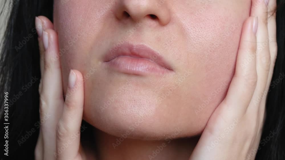Portrait of a woman after 30 with problem skin. Skin texture with enlarged pores. The woman touches the skin of the face, examining it. Portrait of a woman after 30 with problem skin. Skin texture with enlarged pores. The woman touches the skin of the face, examining it.